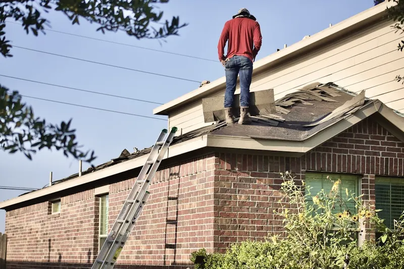 Professional roofer working on a residential roof in Blue Lakes Ridge
